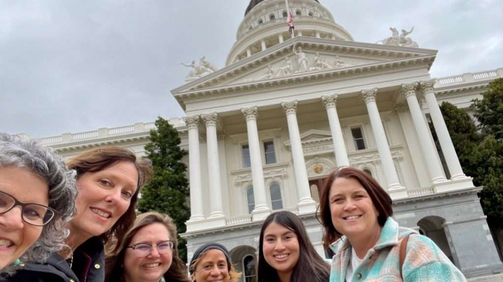 Group of women smiling outside of Capitol building